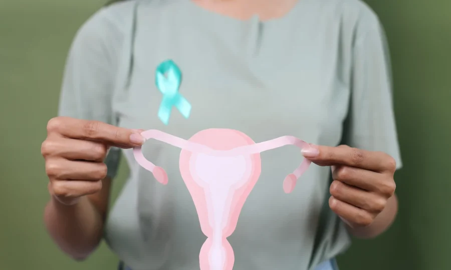 hand-holding-teal-awareness-ribbon-on-cervix-paper-2024-06-14-04-23-07-utc