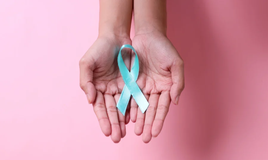 palm-hand-showing-teal-awareness-ribbon-on-globe-o-2023-11-27-05-09-08-utc